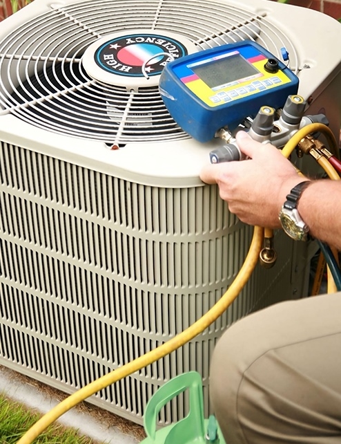 A man is working on an air conditioner