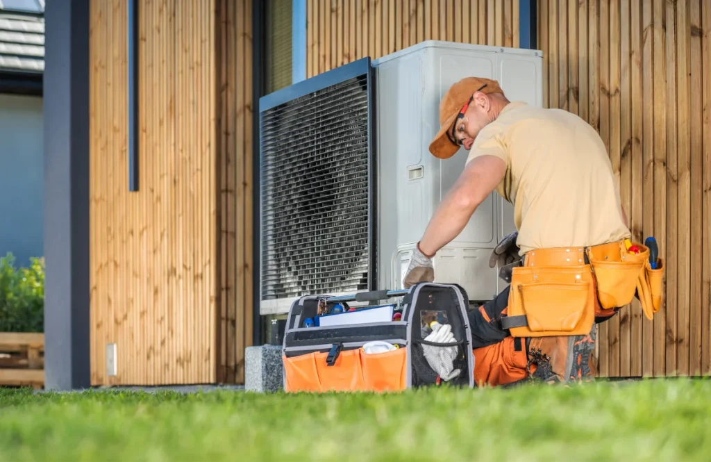 Technician performing heat pump maintenance tasks