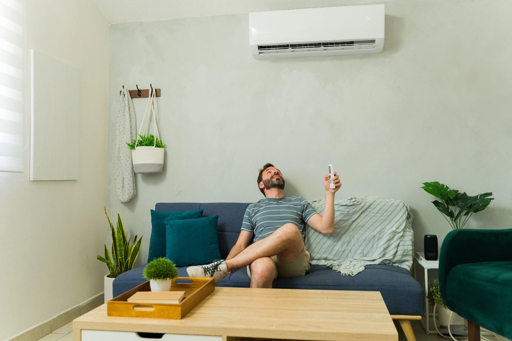 Happy man enjoying comfort from his mini split system