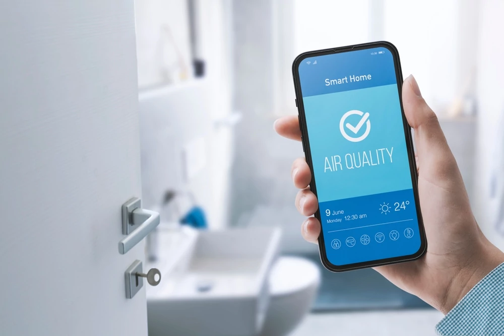 Woman checking air quality in her home using using a smartphone