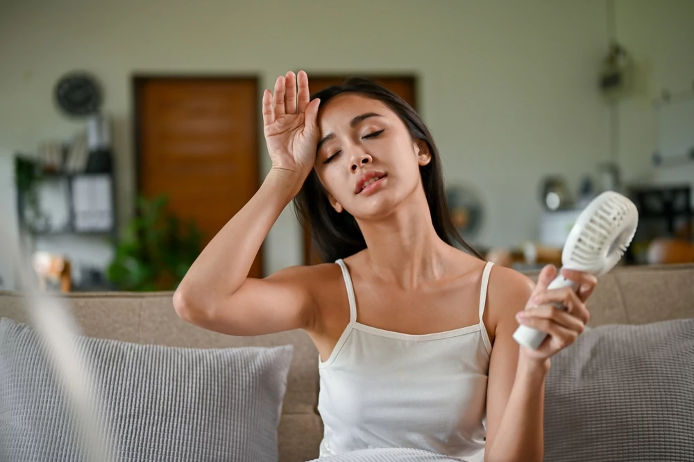 Woman feeling hot because of broken AC